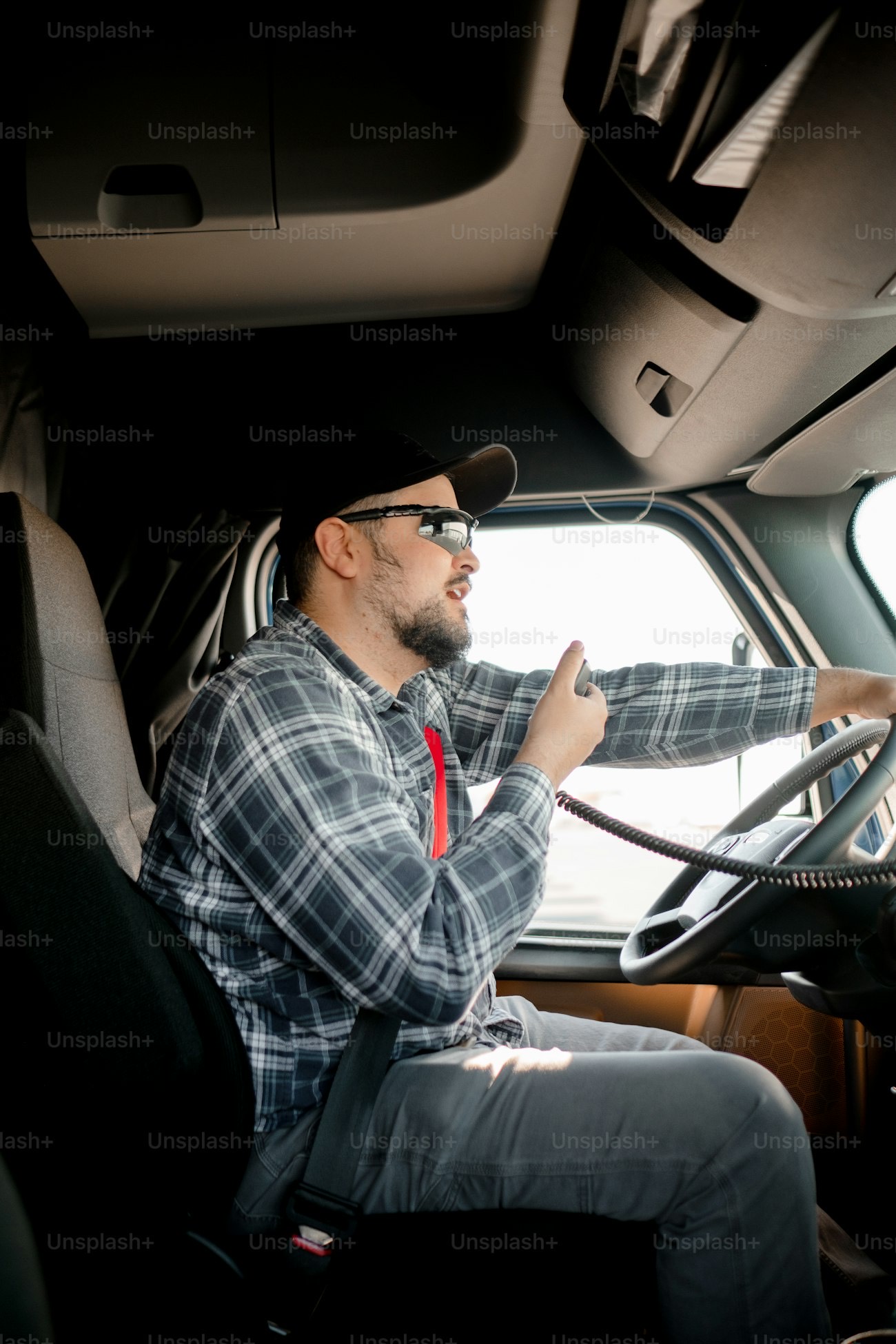 A partner at the wheel of their vehicle