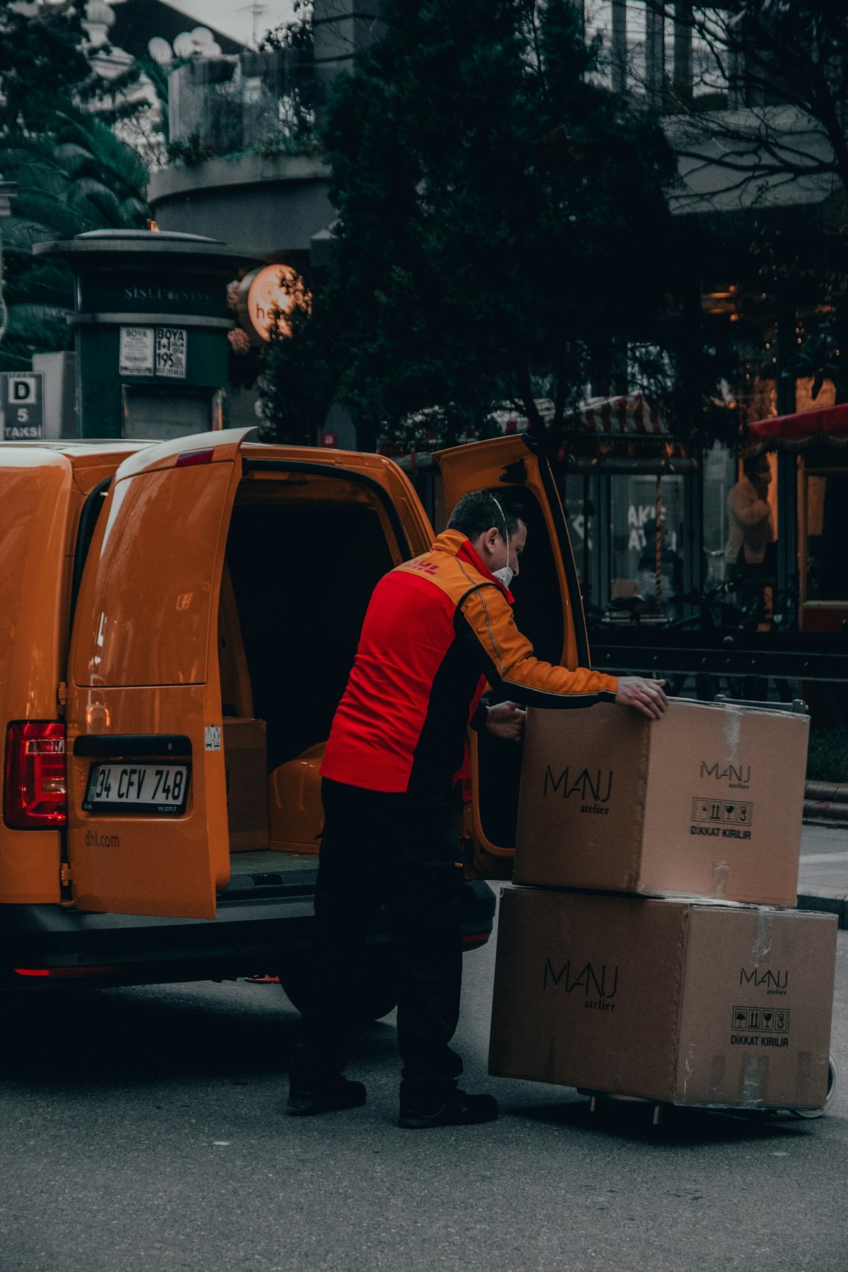A logistics partner standing beside their delivery van